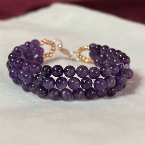 Elegant Handmade Amethyst Beaded Bracelet with rose gold tone accents and clasp.